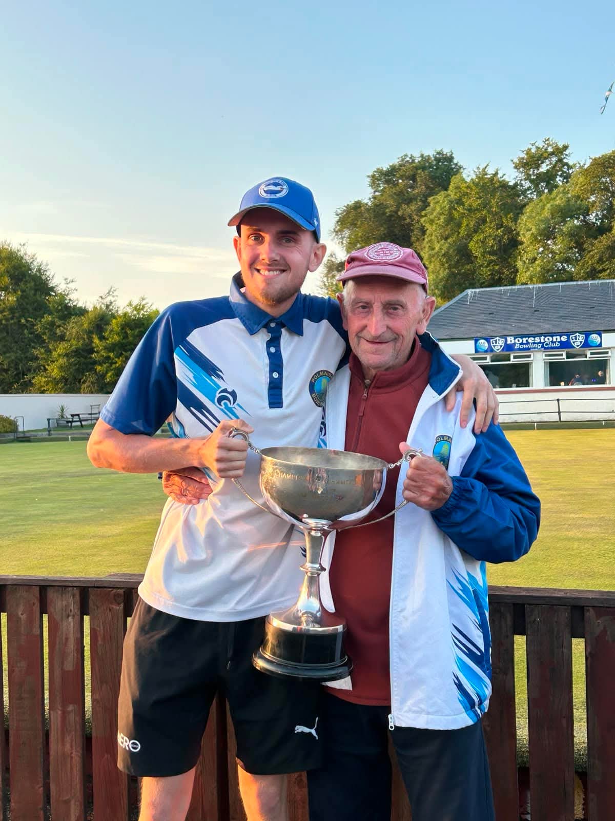 Stirling Area and District Champion of Champions winner Aaron Furzer celebrates his victory with his proud grandad and the trophy at Borestone Bowling Club.